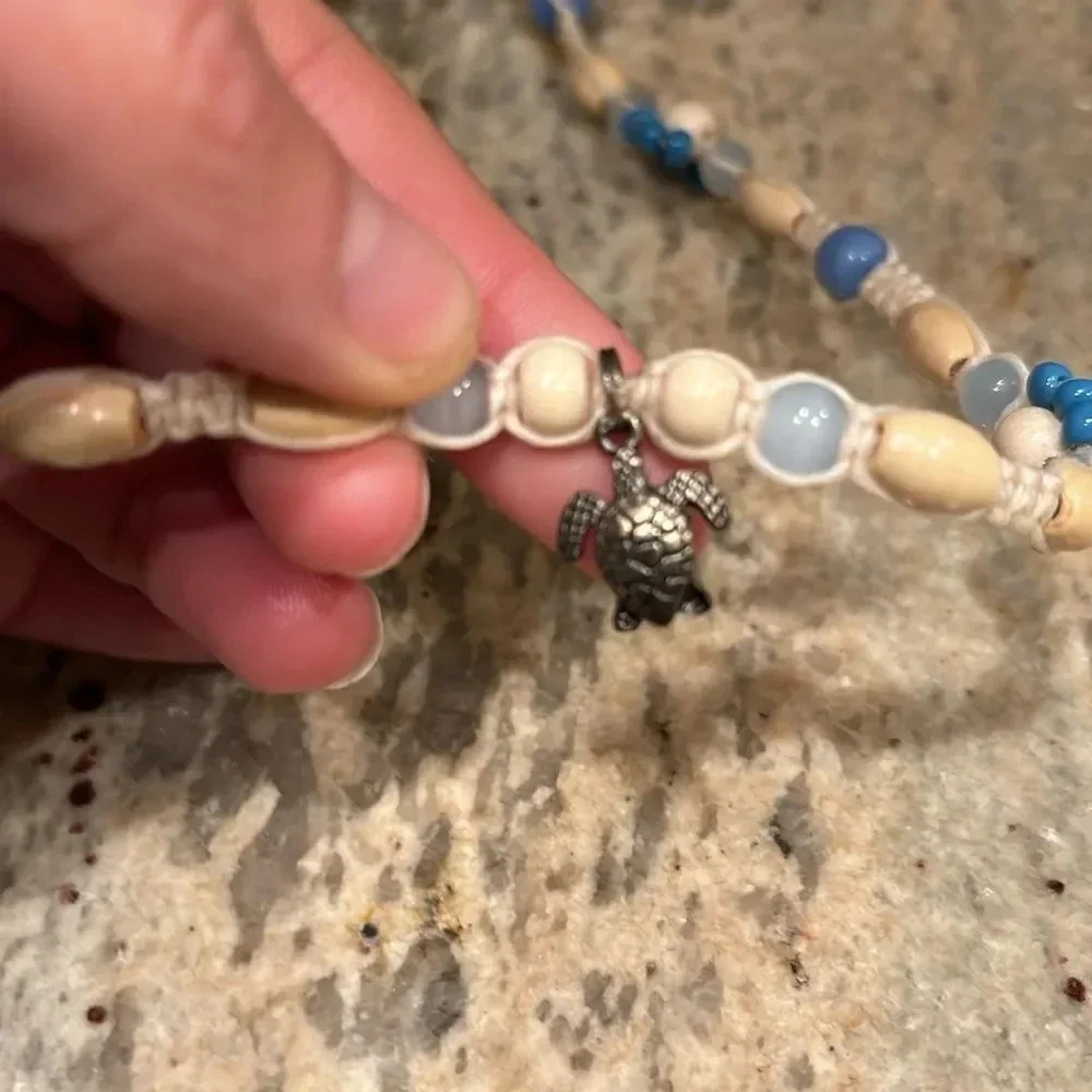 Kids beaded necklace with a silver turtle at the bottom of the necklace